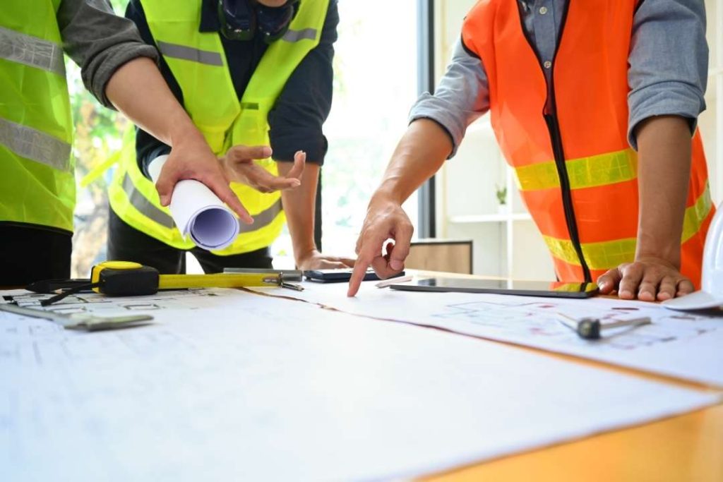 Engineers reviewing plans, from the existing Vitruvius website